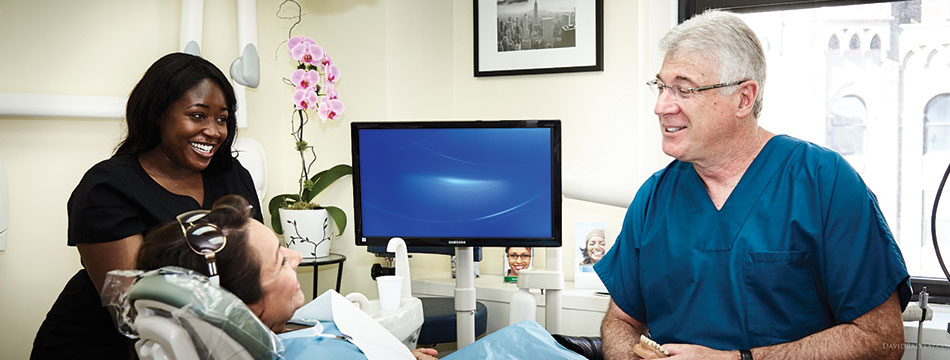 Dentists with patient smiling