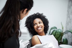 woman smiling in the dentist chair